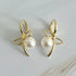 Fuchsia Hercules bowed pearl drop earrings showcasing elegant jewelry with dangling pearl accents and a polished finish.