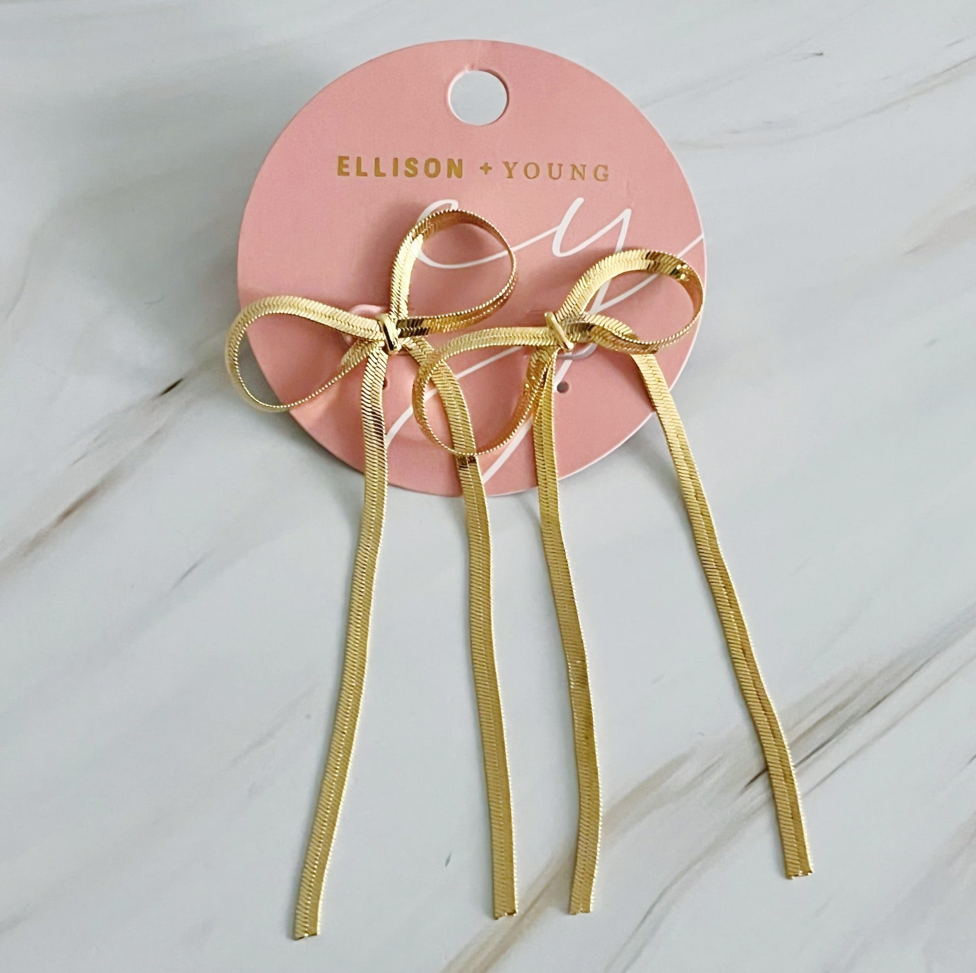 Fuchsia Hercules long drop bow earrings, elegant jewelry with delicate bow design, hanging style, on a white background
