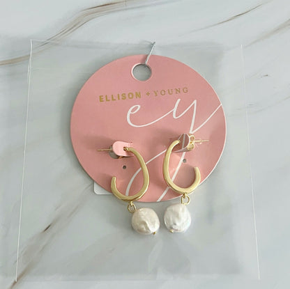 Gold hoop earrings with dangling pearls by Fuchsia Hercules, showcasing elegant jewelry design and intricate craftsmanship.