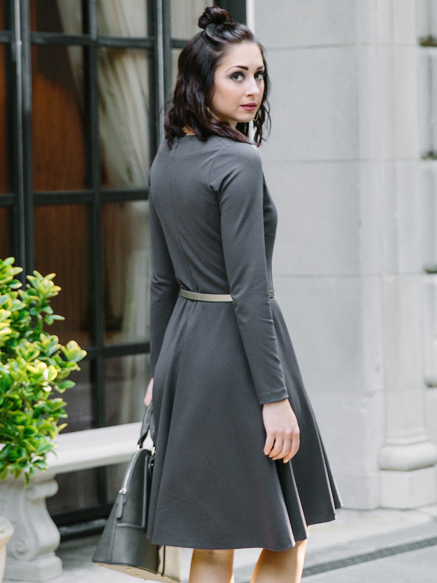 Salmon Bella swing dress with flowing fabric and knee-length design, featuring a sleeveless style and a round neckline.