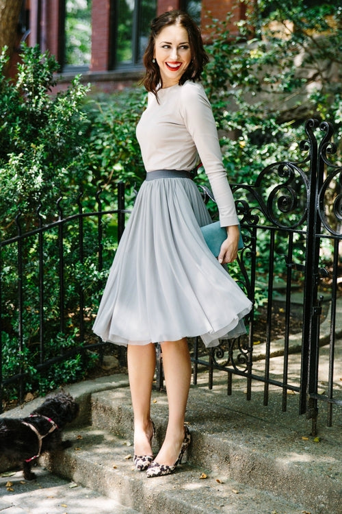 Salmon Bella Sweet Pea skirt in soft, flowy fabric with a floral pattern, displayed on a hanger.