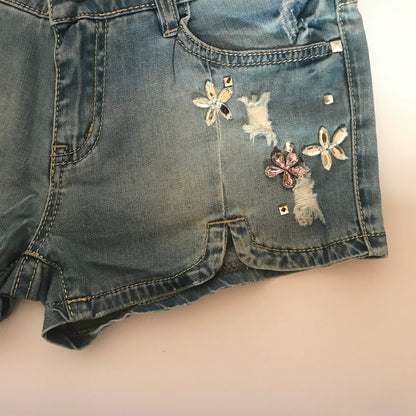 Flower rhinestones denim shorts by Blush Bella featuring floral embellishments and casual denim fabric.