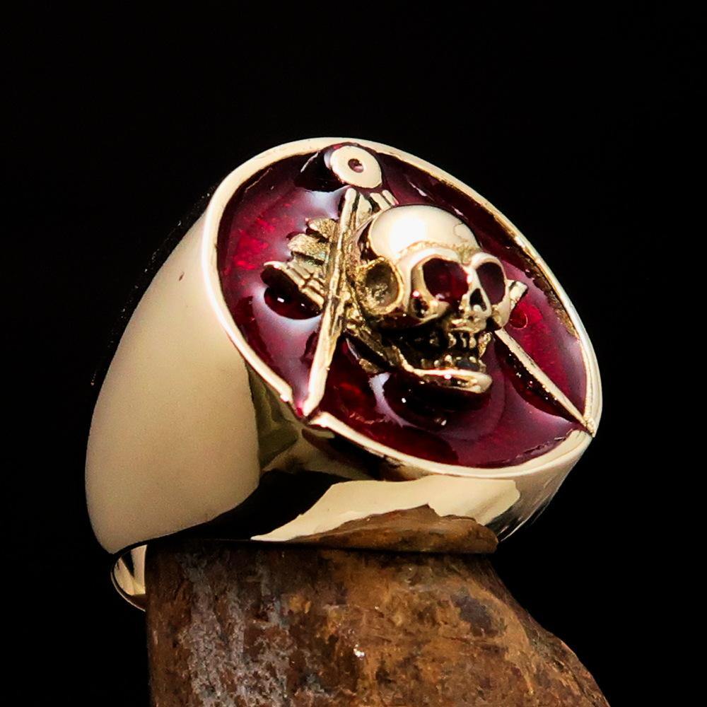 Mens Masonic Skull Ring in red solid brass, detailed design, crafted by Coffee Menoetius, shown on a hand.