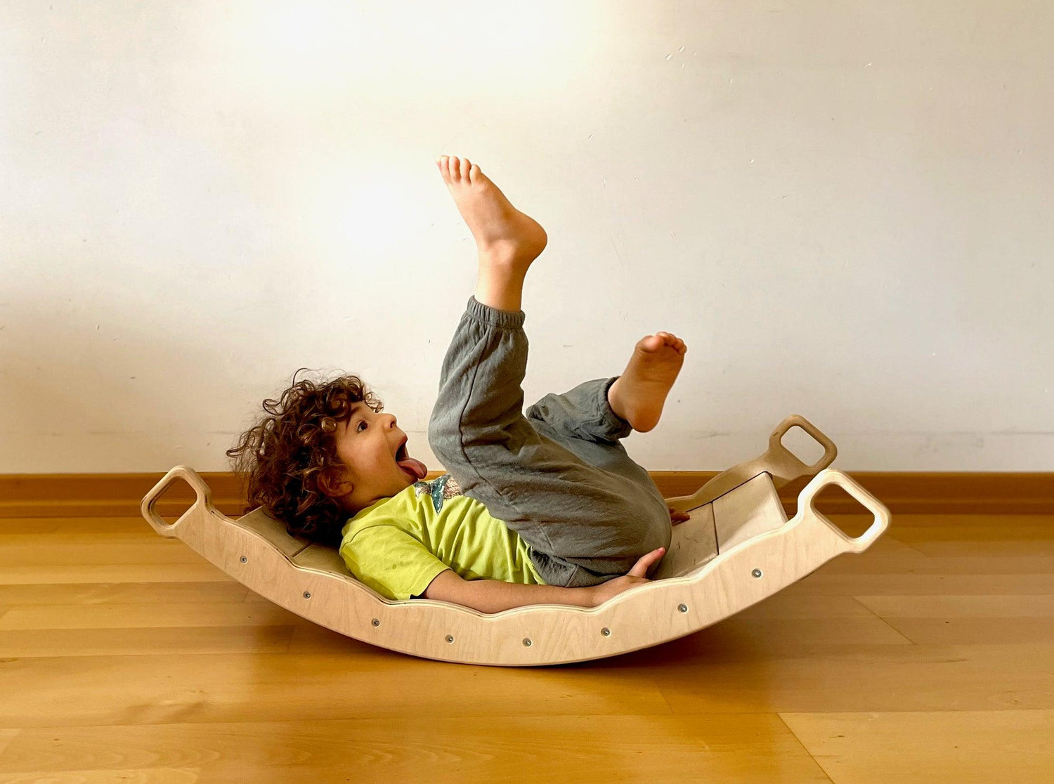 XL Wooden Balance Board with Pillow by Red Oceanus, a piece of furniture designed for stability and comfort, shown with a pillow.
