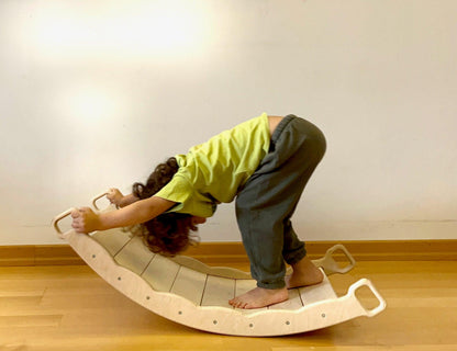 Red Oceanus XL wooden balance board with pillow, versatile furniture piece for stability and relaxation in indoor spaces.