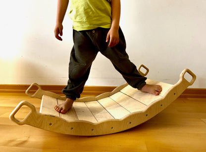 Red Oceanus XL wooden balance board with pillow, a versatile piece of furniture for relaxation and stability.