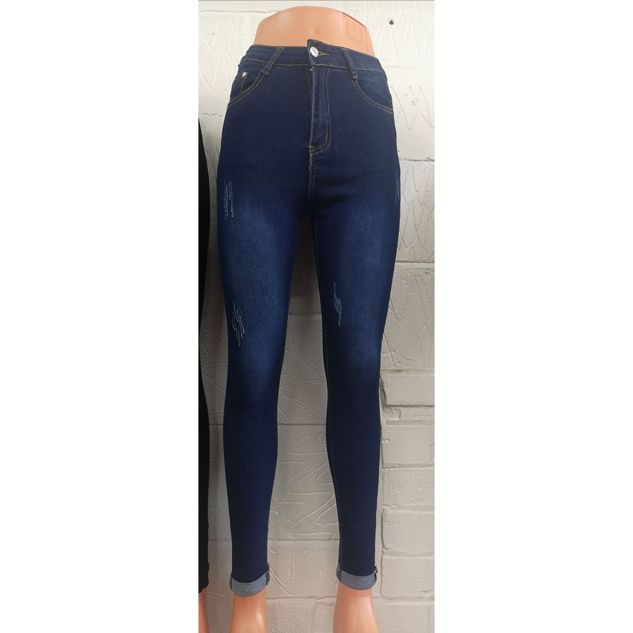 Blue distressed skinny jeans for women by Azure Theseus, showing a close-up of the denim fabric with distressed details.