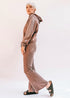 Brown Tartarus Morgan flared pants shown on a model, featuring a high waist and wide-leg design for a stylish, retro look.