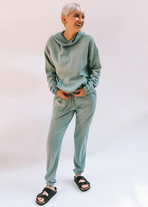 Brown Tartarus Abbi Jogger pants, navy blue with elastic waistband and cuffed ankles, displayed on a hanger.