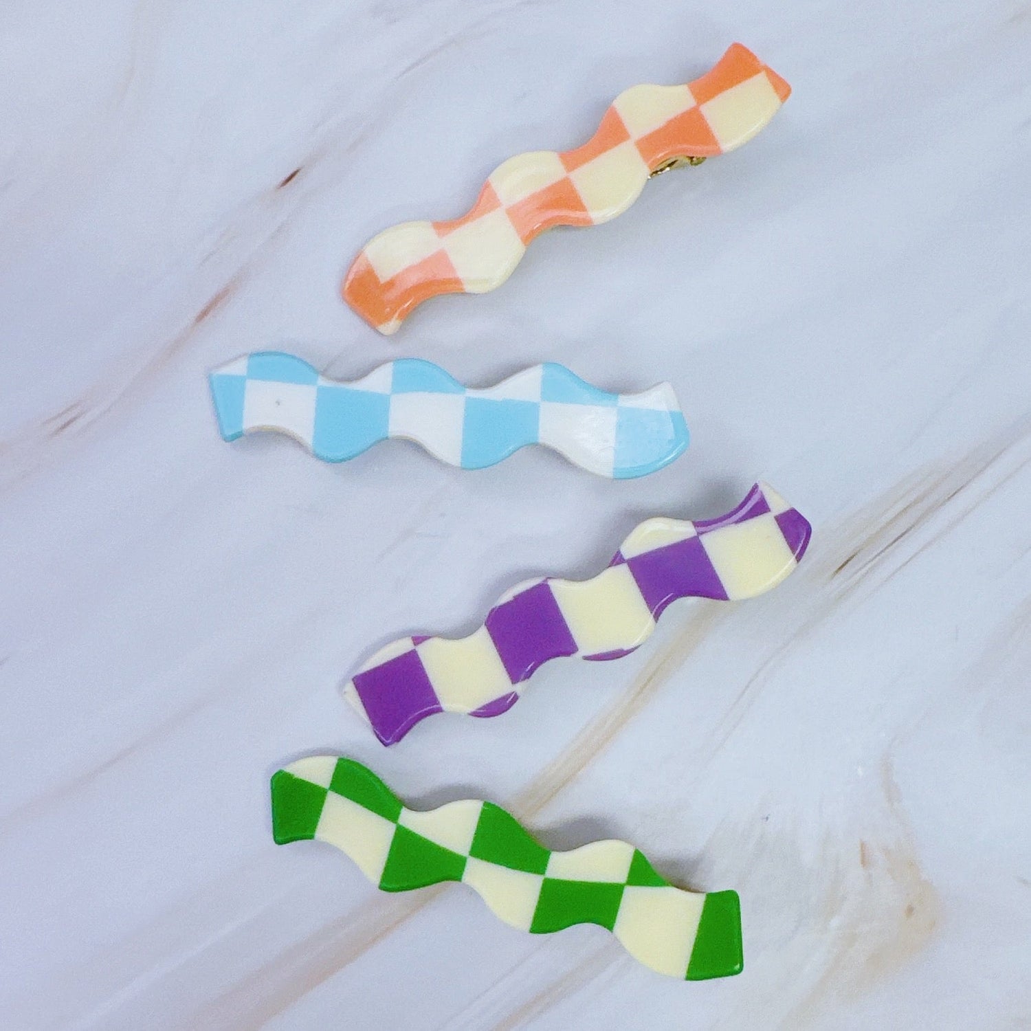 Set of four checkered wavy creaseless hair clips by Fuchsia Hercules, stylish jewelry accessory for hair styling.