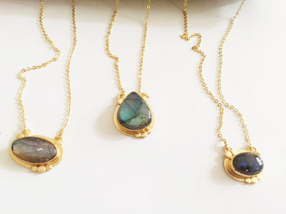 Violet Baobab Agadir Labradorite pendant jewelry featuring a polished labradorite gemstone on a delicate chain.