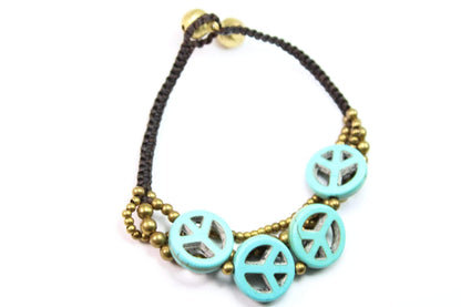 Silver Hestia boho peace symbol bracelet with adjustable cord and engraved peace design, stylish accessory for everyday wear.