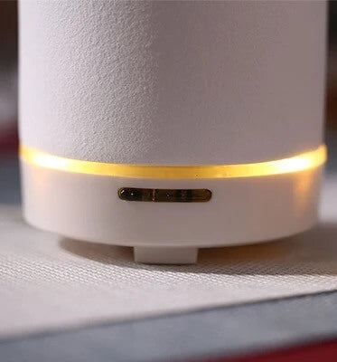 White Dione stone aromatic diffuser with elegant design, showcasing its natural stone finish and ceramic components for home scenting.