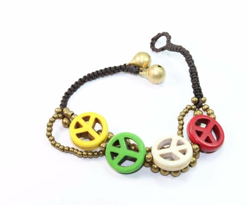 Silver Hestia boho peace symbol bracelet with adjustable cord and silver accents, laid out on a white background.