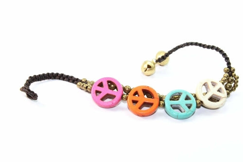 Silver Hestia boho peace symbol bracelet with adjustable cord and metal charm, showcasing a relaxed, stylish design.