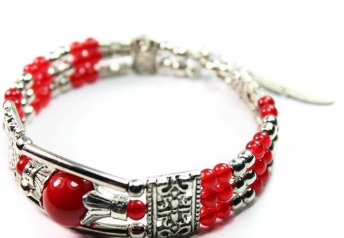 Silver Hestia feather charm and beads bracelet with delicate silver accents and adjustable chain on a white background.