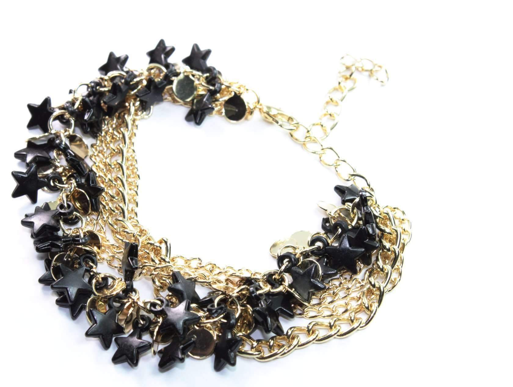 Silver Hestia three-tier star charm bracelet with layered silver chains and star pendants on a neutral background.