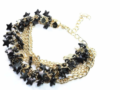 Silver Hestia three-tier star charm bracelet with delicate chains and star pendants, showcasing a stylish layered jewelry design.