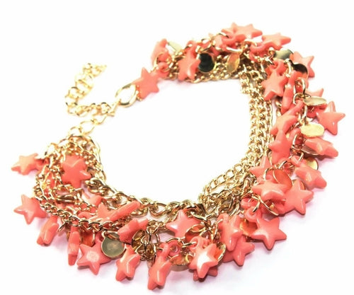 Silver Hestia three-tier star charm bracelet featuring layered silver chains and star pendants on a neutral background.