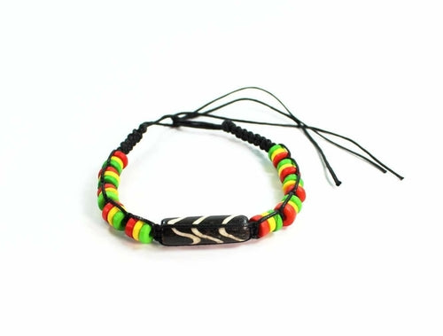 Silver Hestia friendship bracelet with chevron pattern and Rasta vibes featuring colorful thread and adjustable clasp.