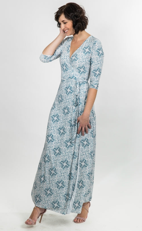 Salmon Bella Natalie dress displayed on a hanger, featuring a stylish, elegant design with flowing fabric and detailed neckline.