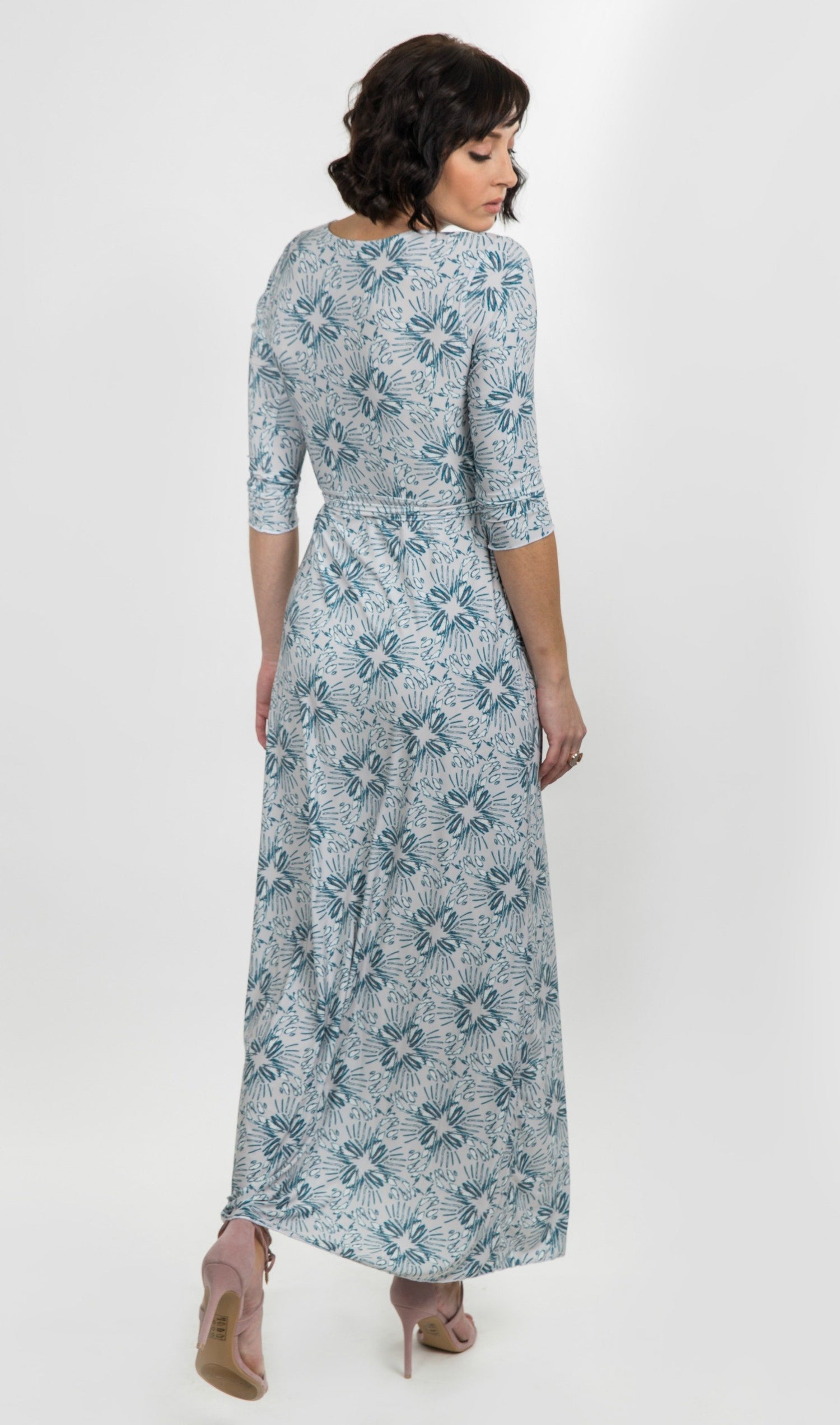 Salmon Bella Natalie dress displayed on a hanger, showcasing its elegant design and fabric details.