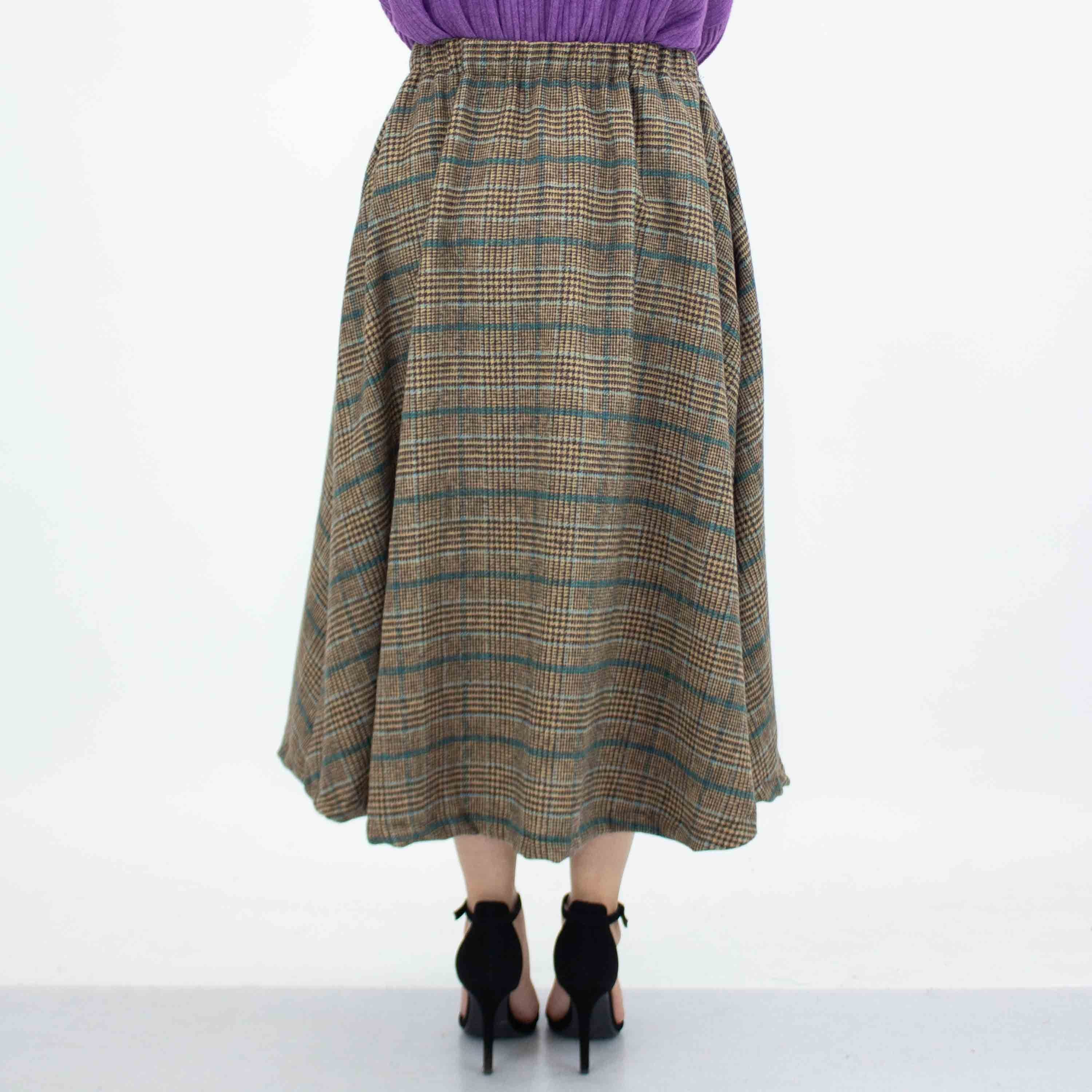 Blue plaid flare midi skirt with side pockets by Yellow Hera, showcasing its stylish design and comfortable fit.