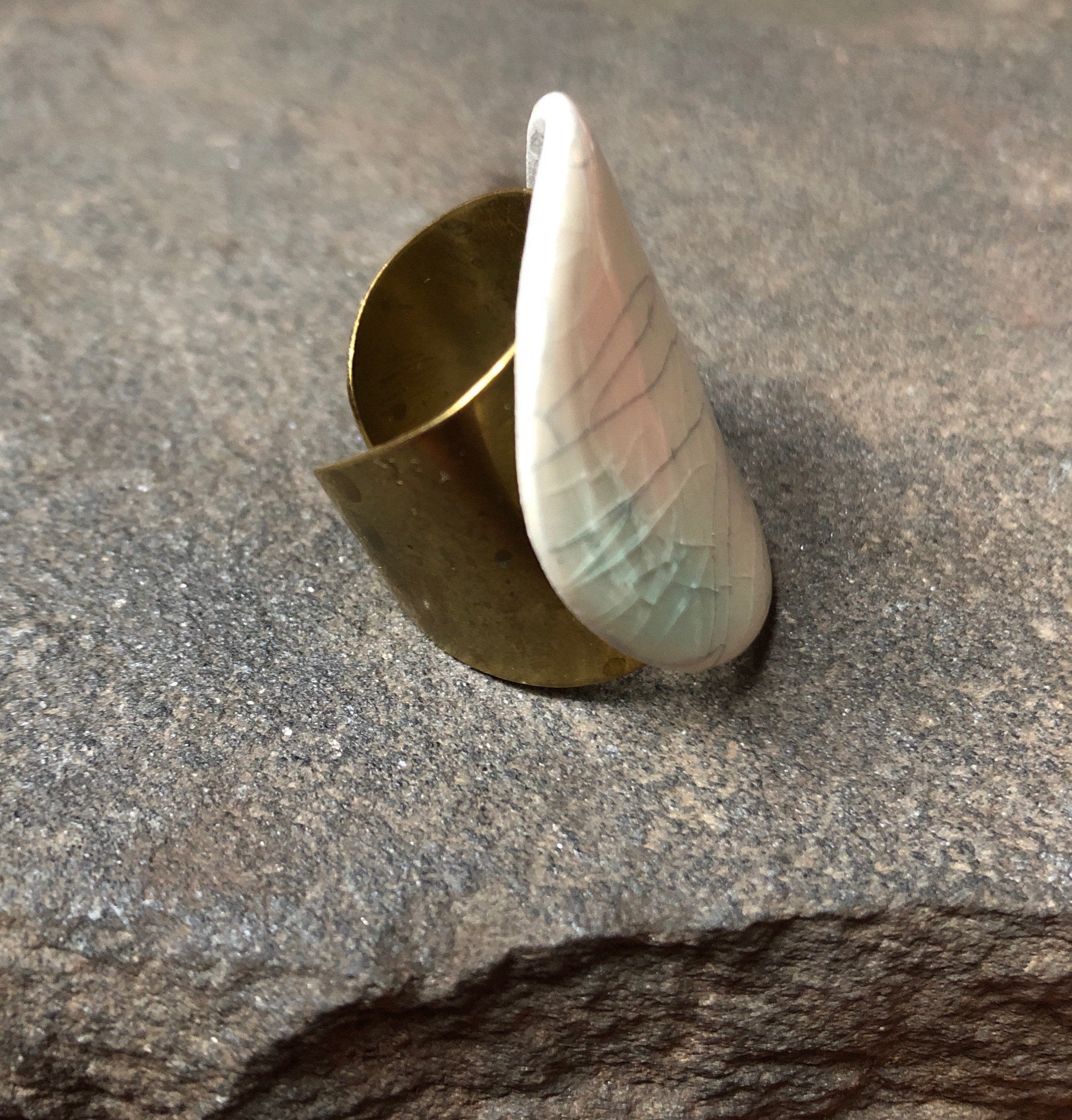 Adjustable handmade ceramic cocktail ring by Azure Nesoi featuring a vibrant teal band and unique statement design.