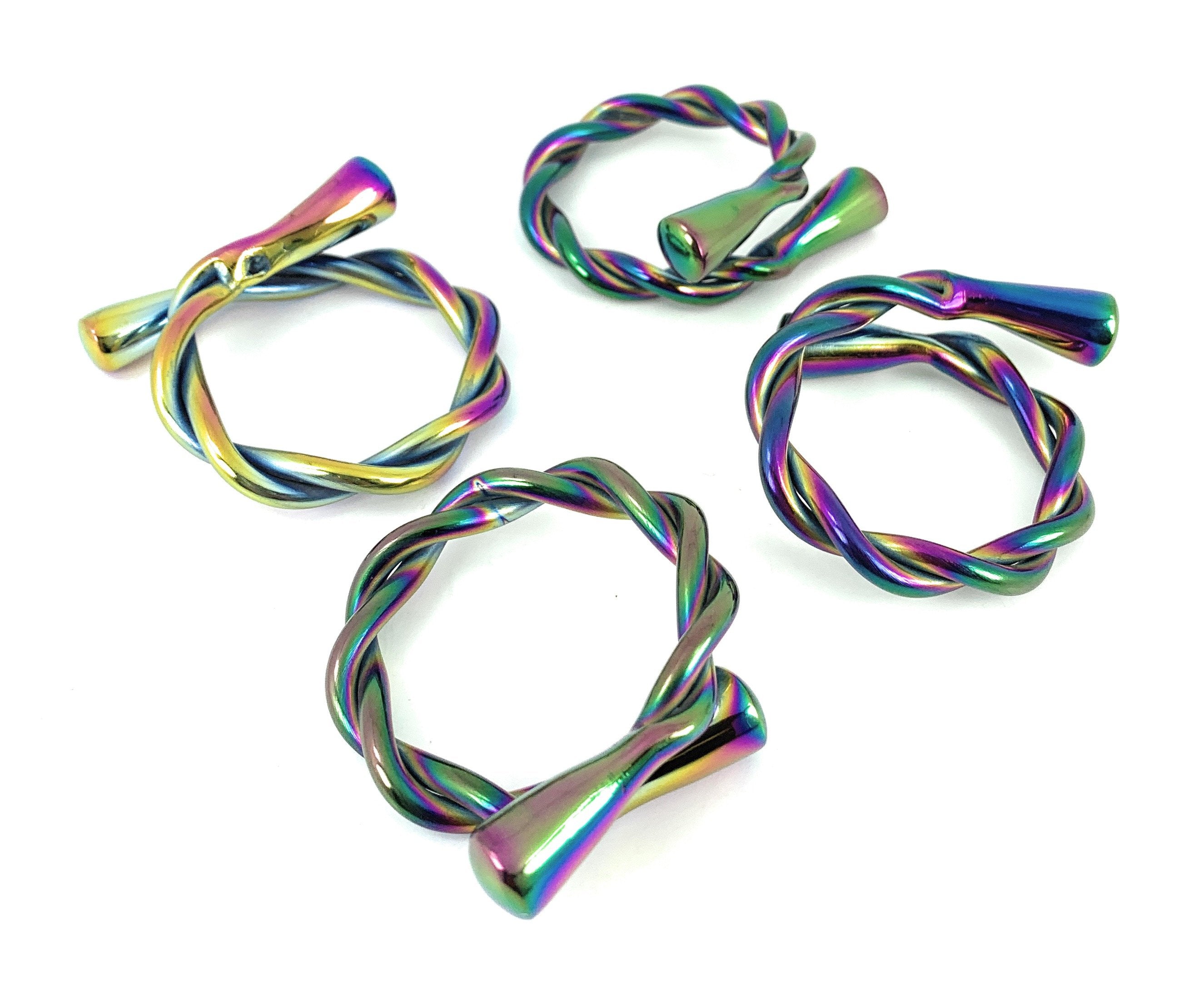 Set of four rainbow Vibhsa modern napkin rings by Gold Juniper, dishwasher safe, perfect for stylish table arrangements.