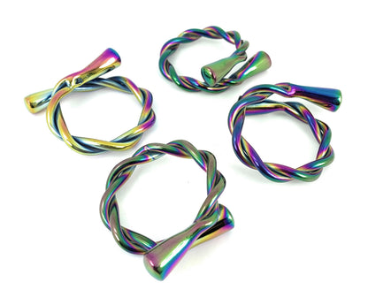 Set of four rainbow Vibhsa modern napkin rings by Gold Juniper, dishwasher safe, perfect for stylish table arrangements.