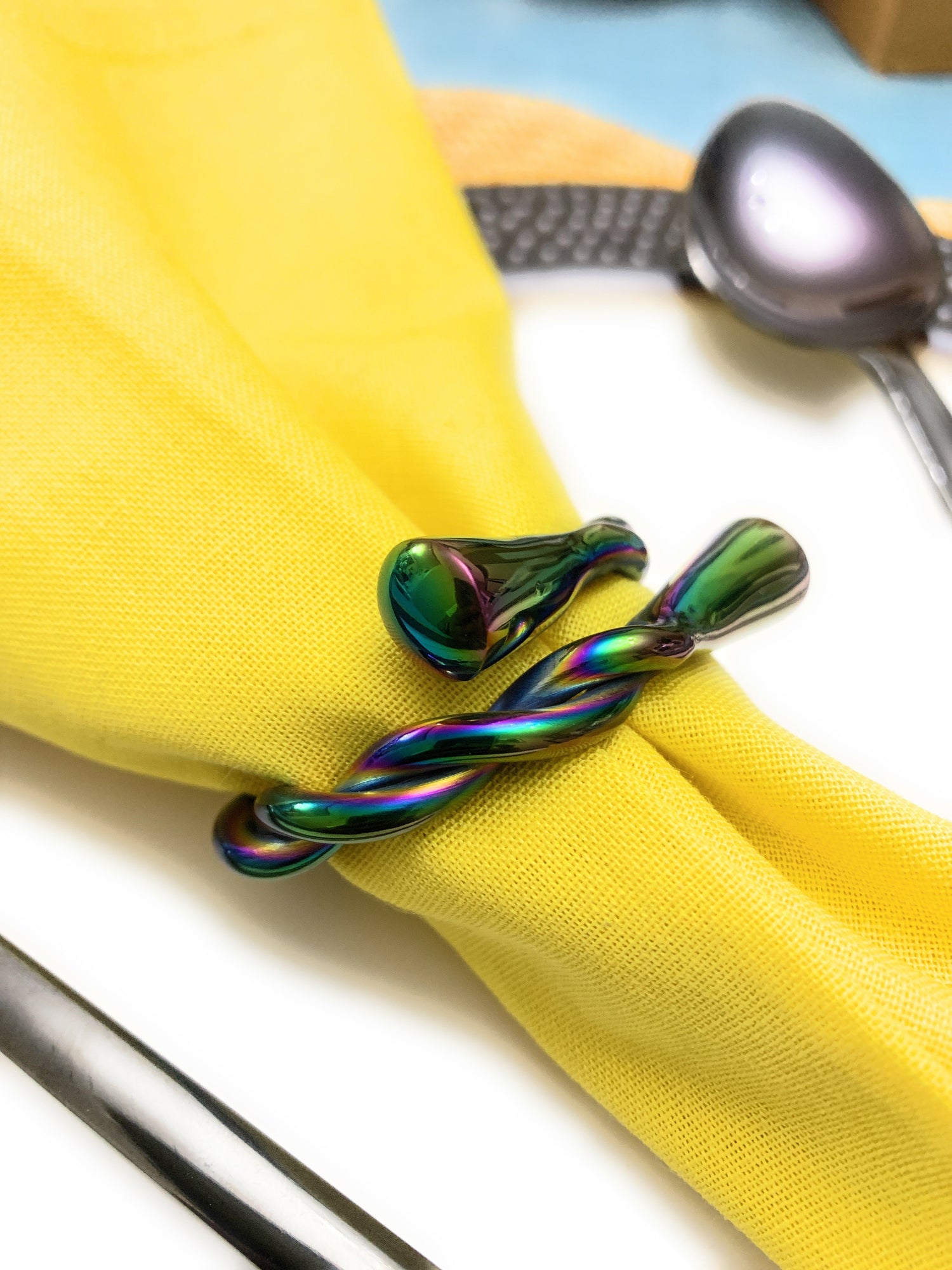 Set of four Vibhsa modern rainbow napkin rings by Gold Juniper, dishwasher safe, perfect for stylish table decor.