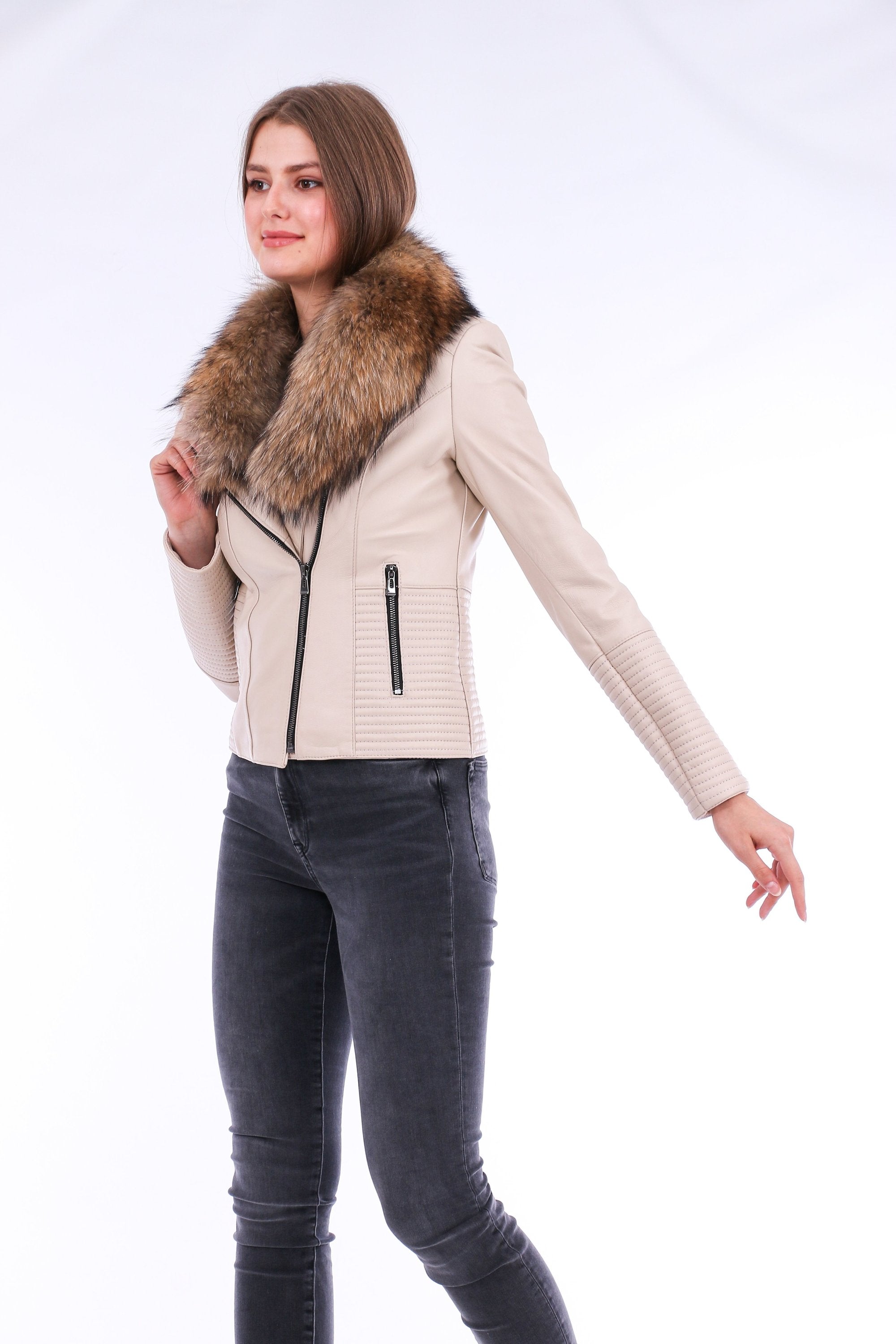 White Ravenna leather biker jacket by Sangria Iapetus hanging on a display rack with detailed stitching and silver hardware.