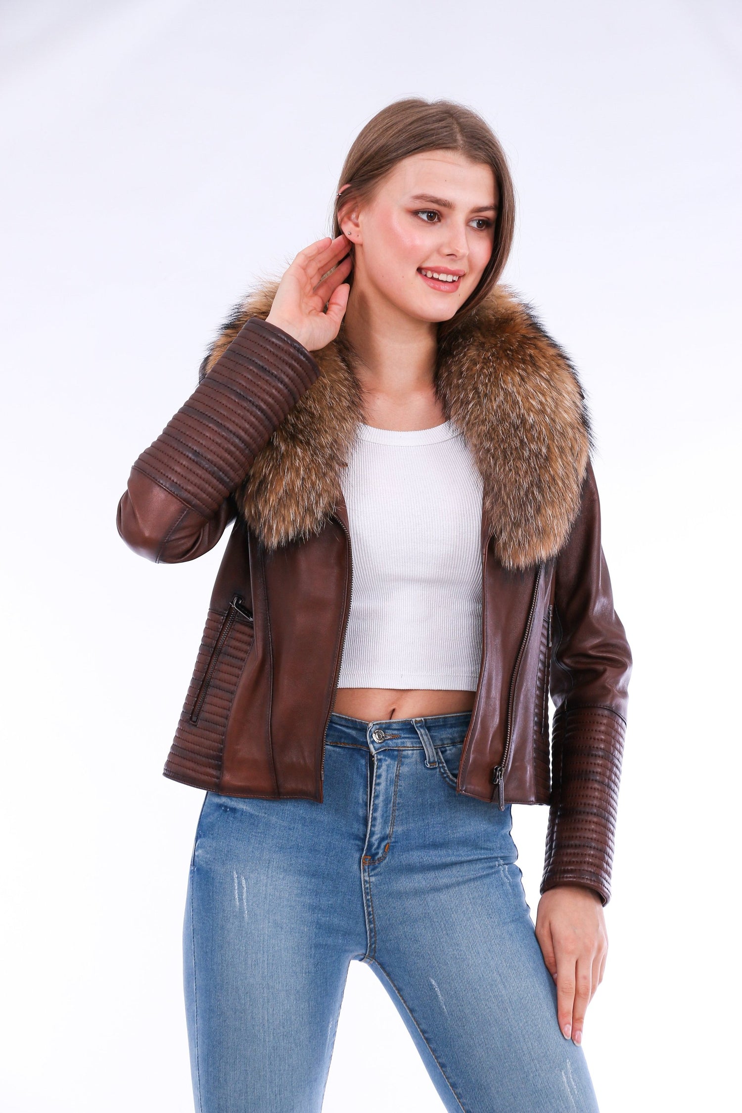 Brown Ravenna leather biker jacket by Sangria Iapetus with silver hardware and fitted style, displayed on a hanger.
