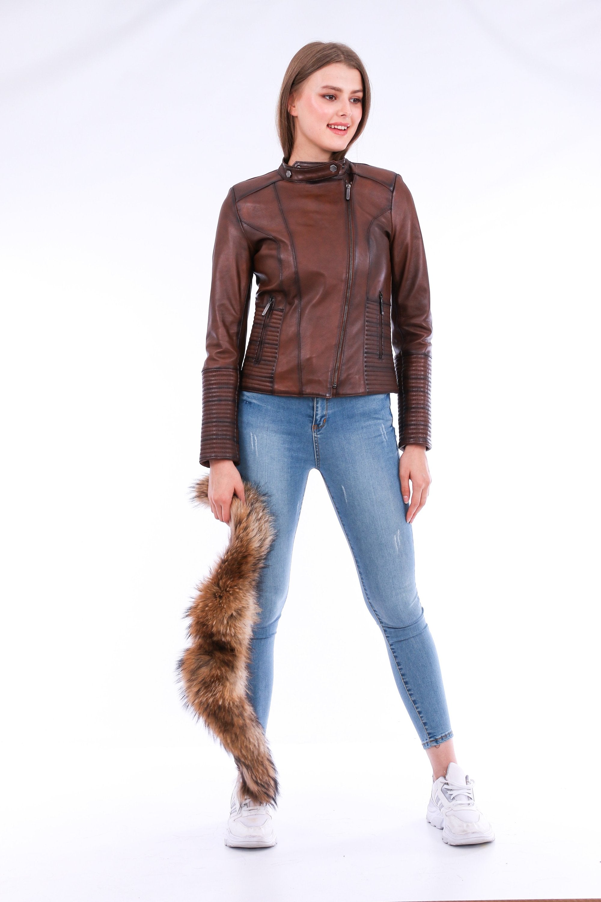 Brown Ravenna leather biker jacket by Sangria Iapetus with silver hardware, displayed on a hanger against a neutral background.