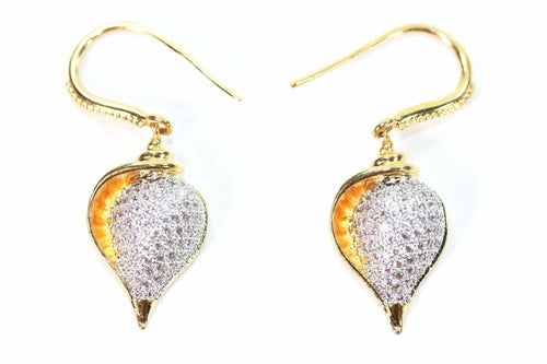 Silver Hestia conch shell earrings featuring natural, polished conch shells with silver hooks for a boho-inspired jewelry look.