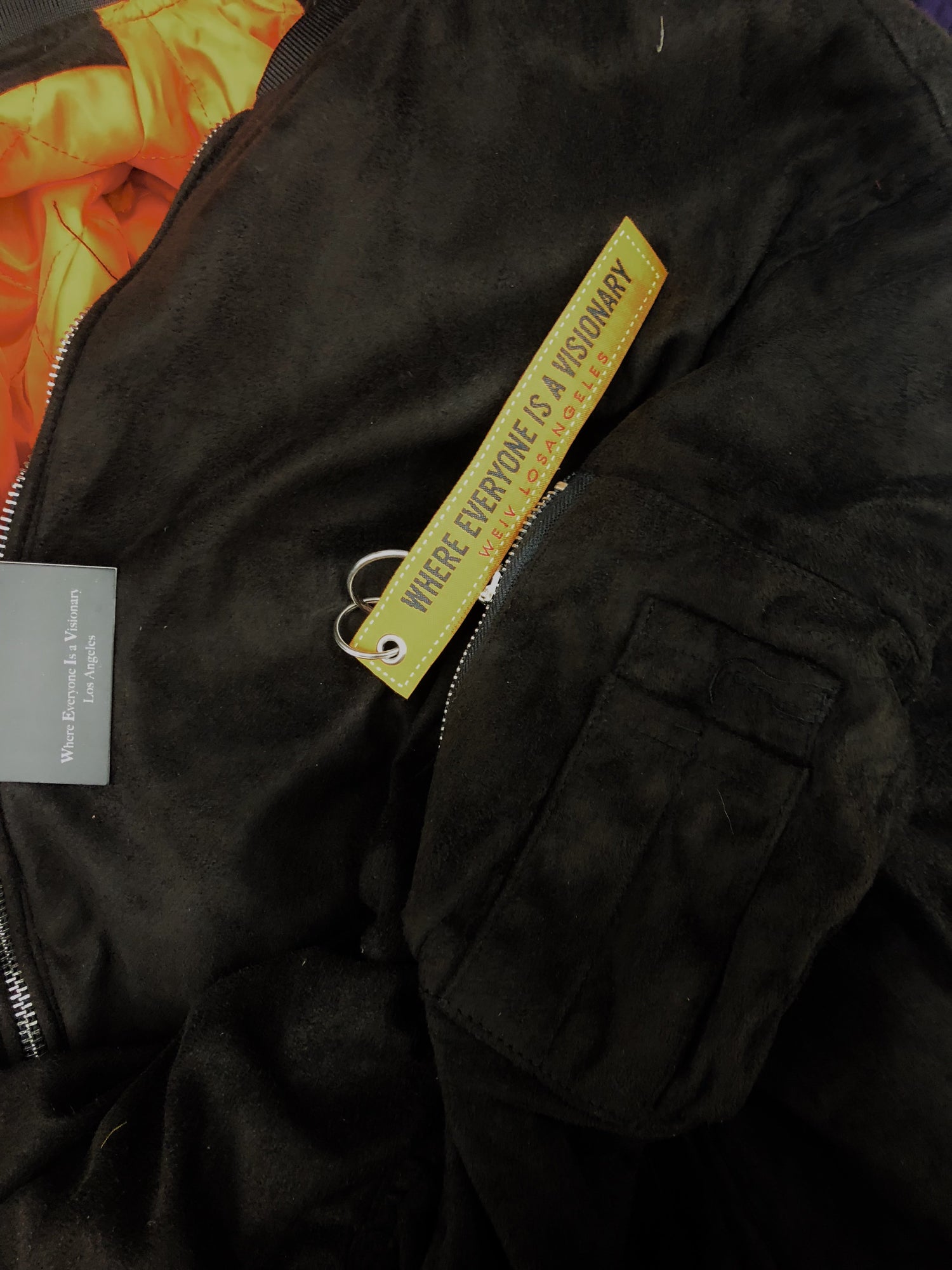Lime Milo faux suede bomber jacket, stylish and lightweight, shown in a close-up image highlighting the beige fabric and ribbed cuffs.