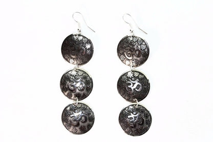 Silver Hestia three-tier om earrings with lotus petal design, featuring dangling silver earrings with intricate lotus motifs.
