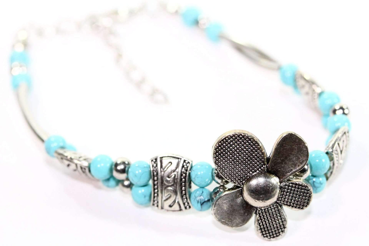 Silver Hestia petal flowers bracelet featuring silver flower charms and delicate chain design, perfect for elegant jewelry styling.
