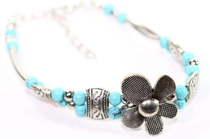 Silver Hestia petal flowers bracelet featuring silver flower charms and delicate chain design, perfect for elegant jewelry styling.