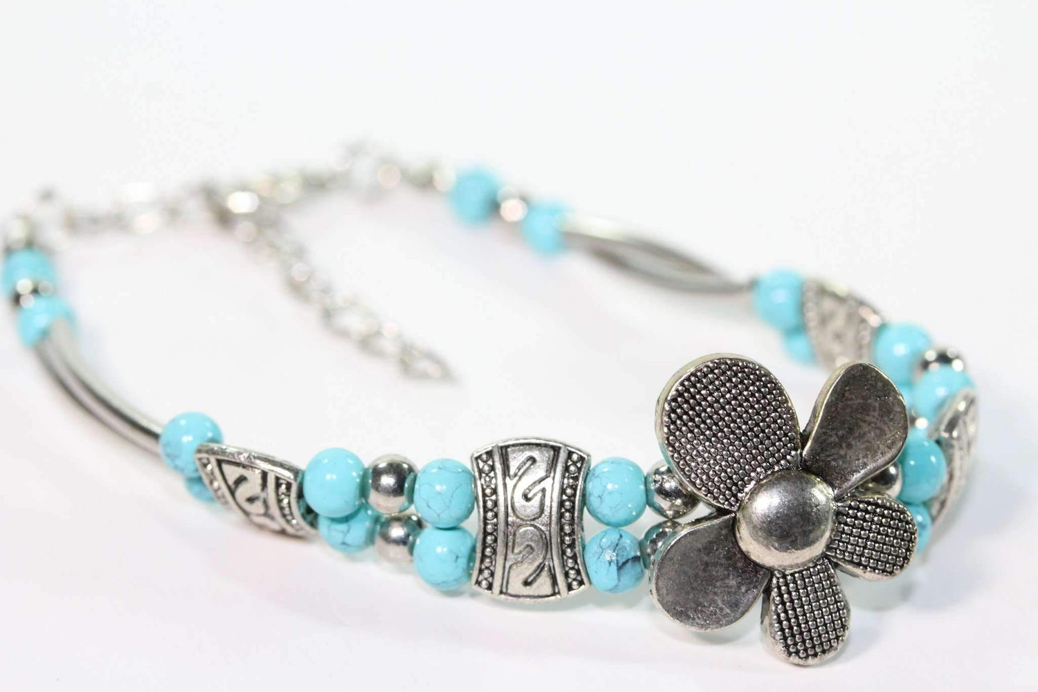 Silver Hestia petal flower bracelet with delicate silver petals and floral design, showcasing an elegant jewelry piece.