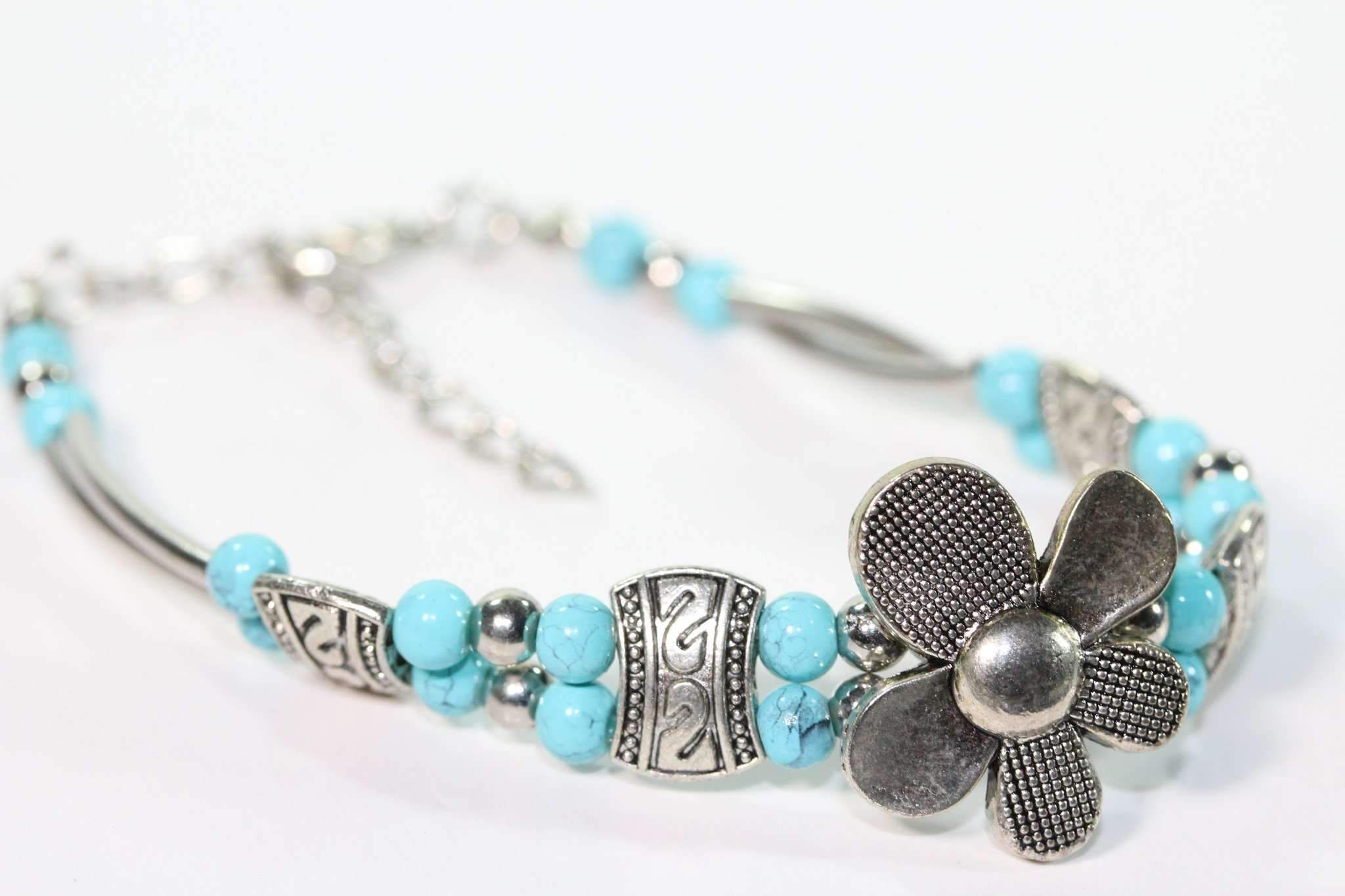 Silver Hestia petal flower bracelet with delicate silver petals and floral design, showcasing an elegant jewelry piece.
