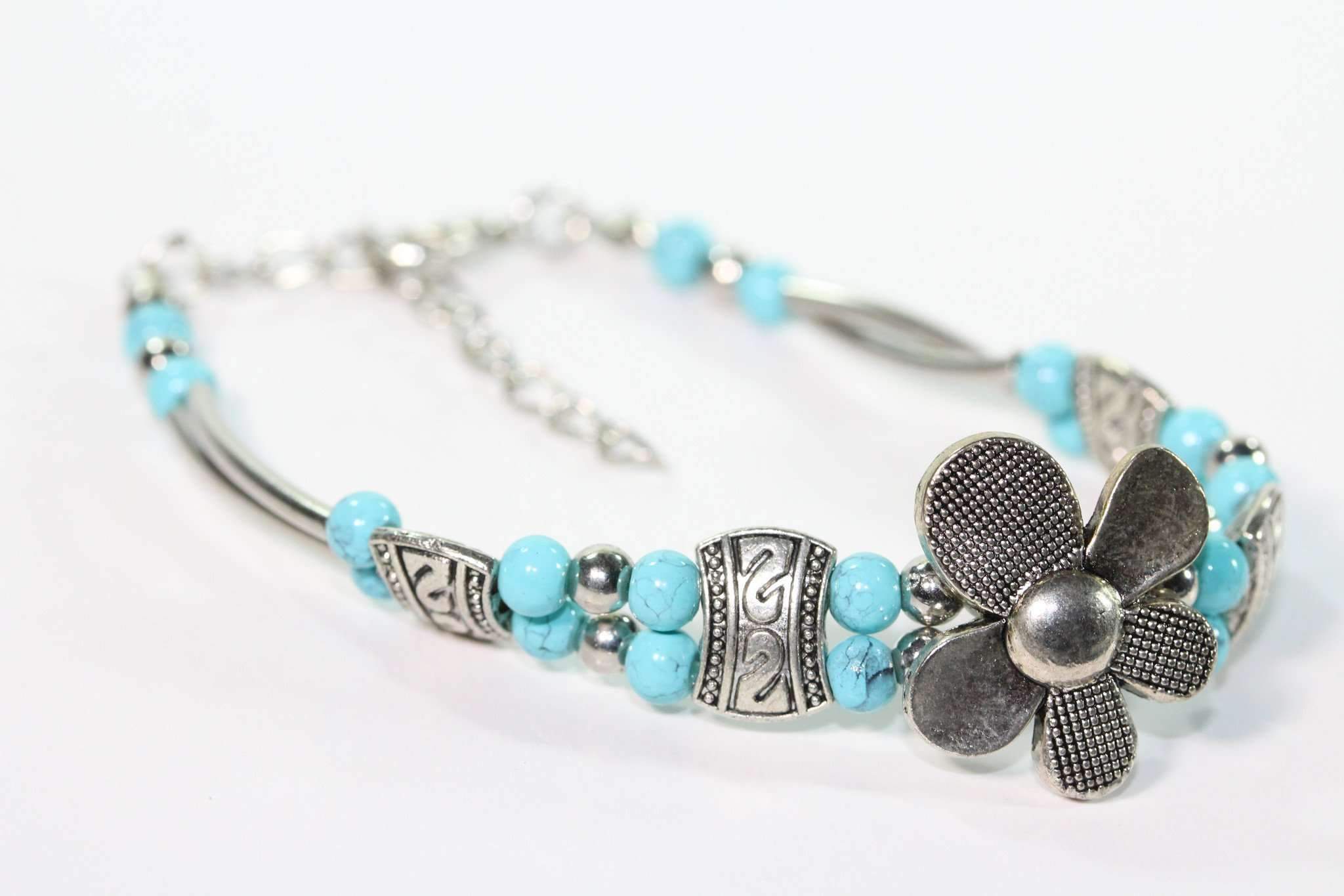 Silver Hestia petal flower bracelet with intricate silver floral design, showcasing elegant jewelry for petal-inspired style.