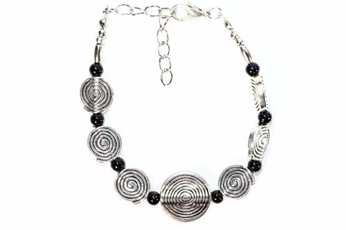 Silver Hestia Infinity Spiral Charm Bracelet featuring a sleek, silver design with an infinity spiral charm on a delicate chain.