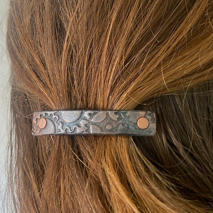 Copper and silver metallic steampunk gear stamped leather hair accessory by Orange Themis, featuring intricate gear designs for hair styling.