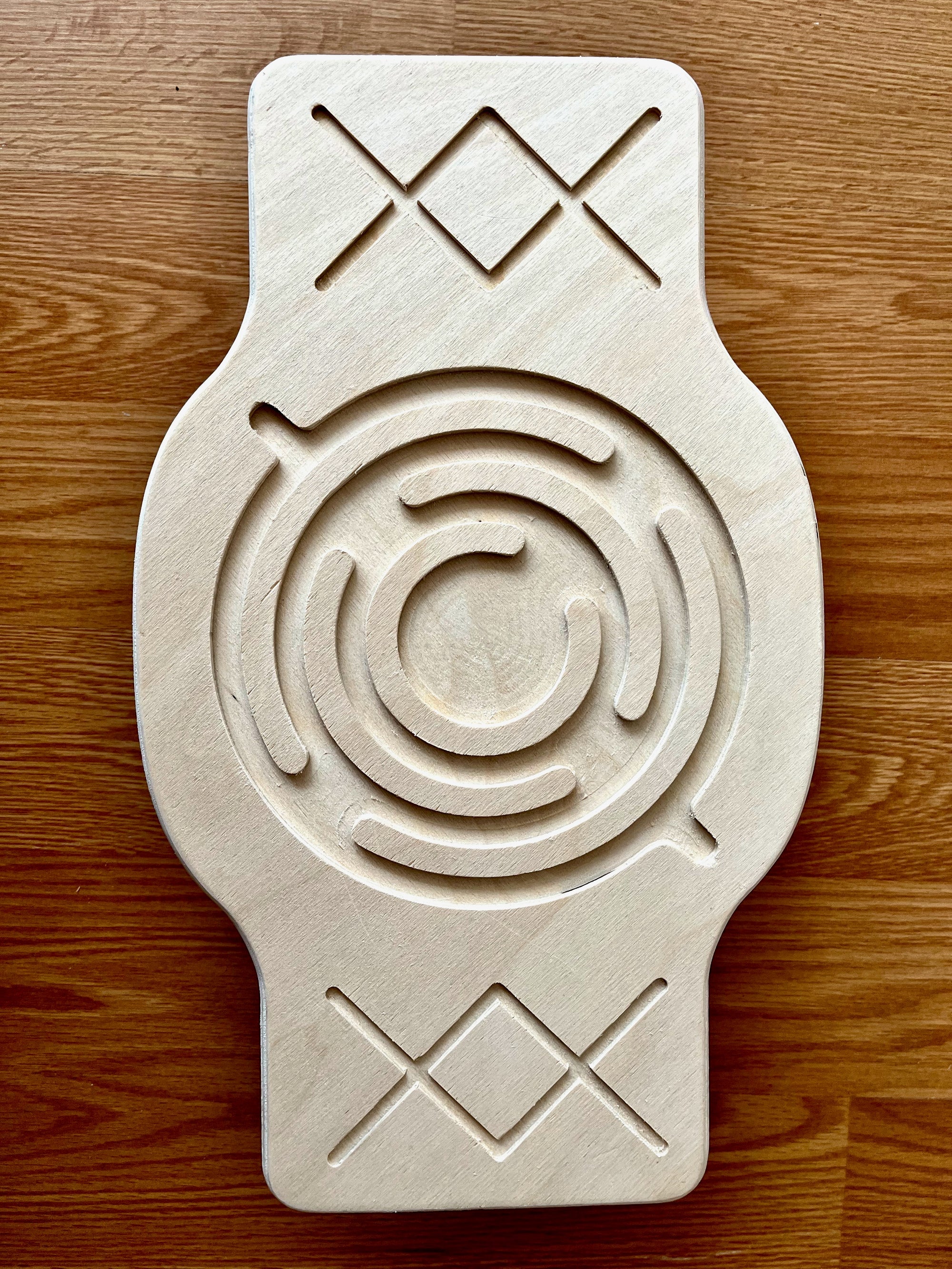 Red Oceanus Maze Wooden Balance Board, a natural wooden furniture piece designed for balance and stability exercises.
