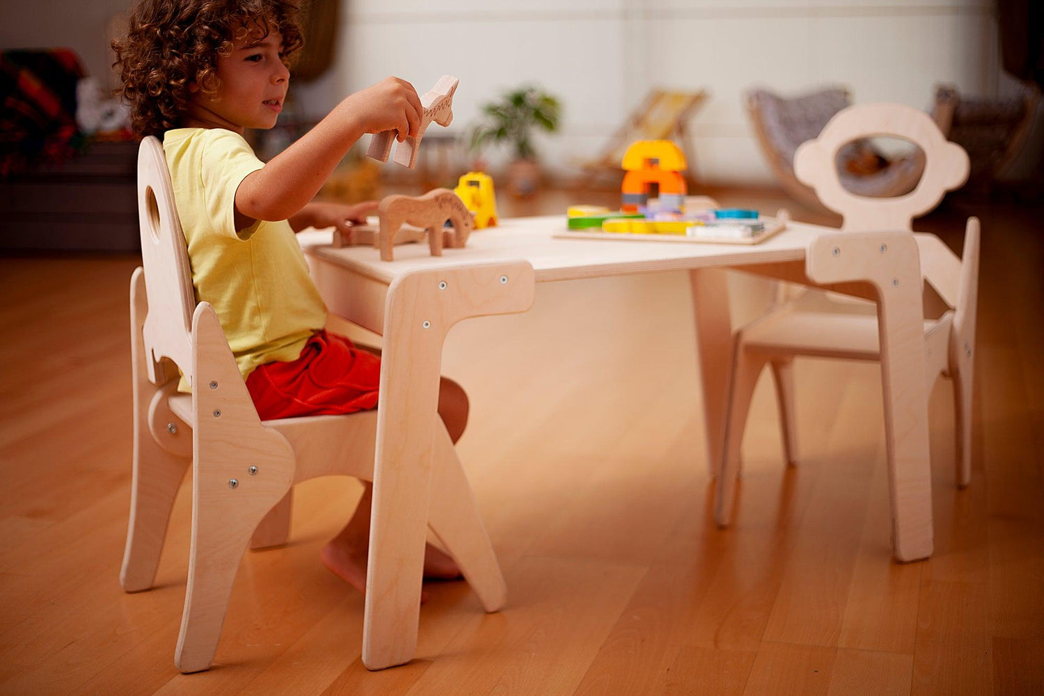 Red Oceanus Montessori table and chair set for children, featuring sturdy wooden furniture with a natural finish for learning and play.