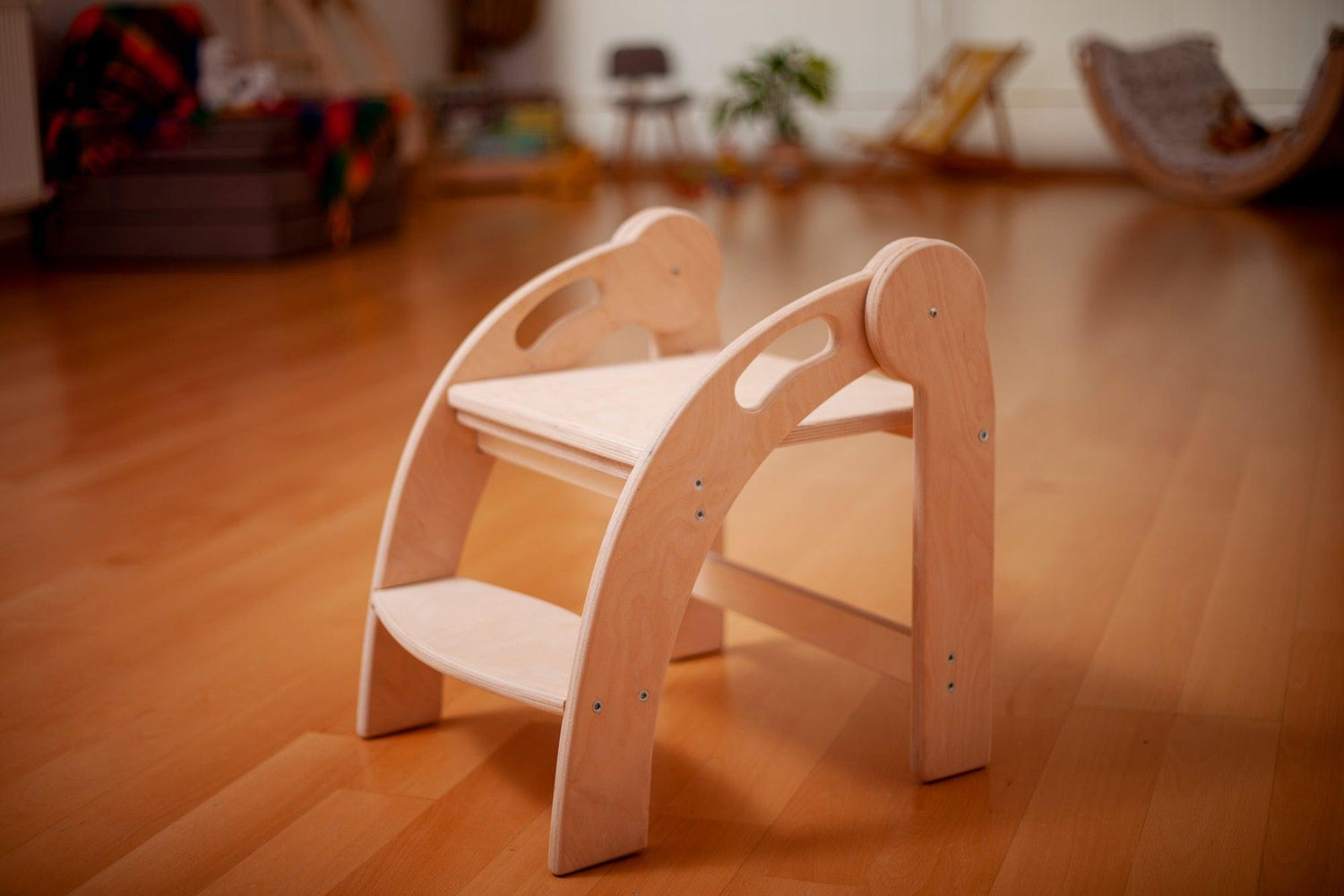 Red Oceanus foldable Montessori kitchen step stool showing a sturdy wooden design with a foldable feature for easy storage.