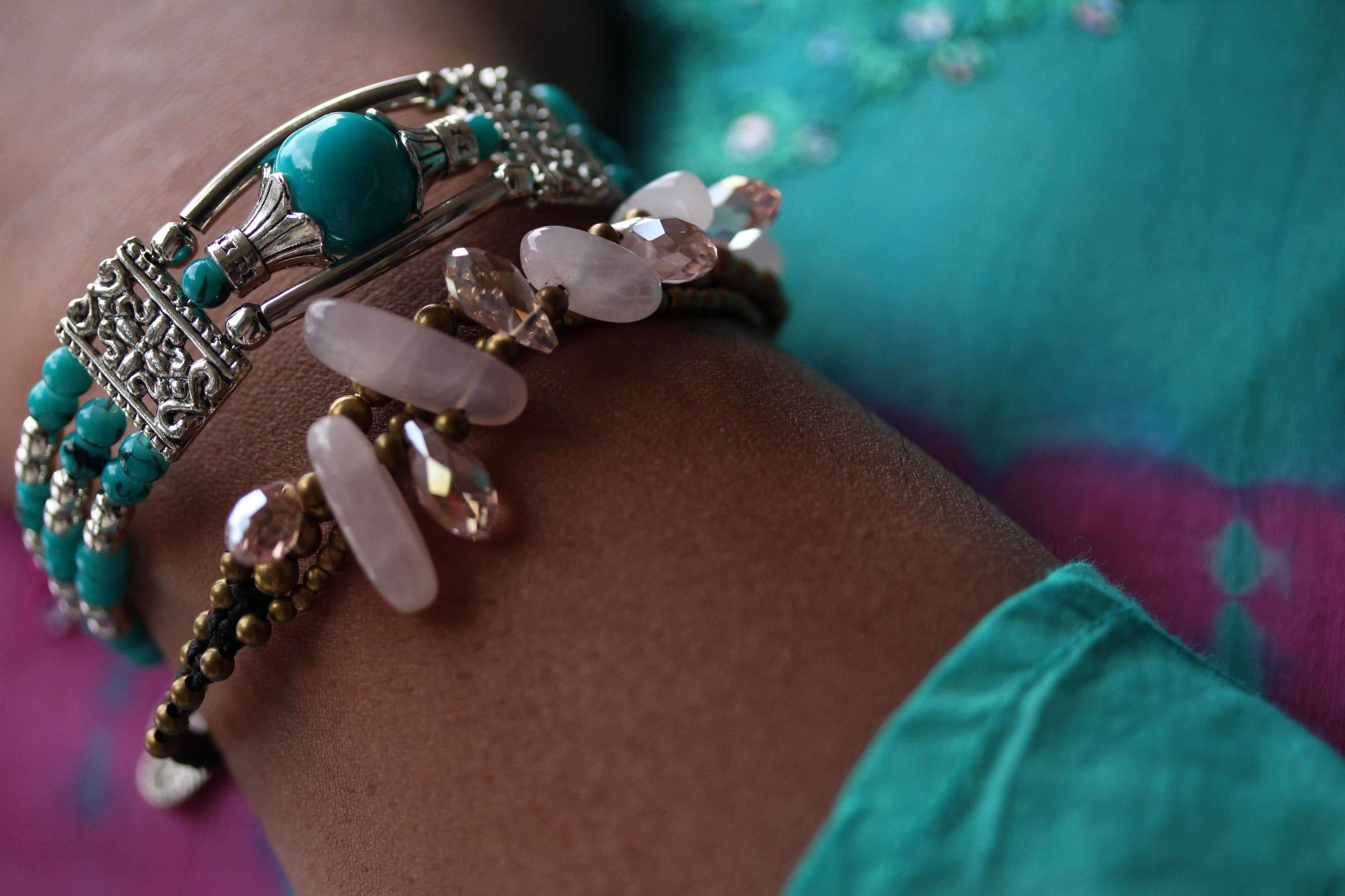 Silver Hestia feather charm and beads bracelet with delicate silver charms and colorful beads, stylish jewelry accessory.