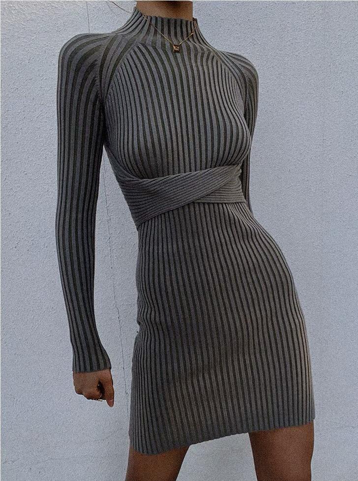 Azure Thanatos Malika Knit Dress displayed on a hanger, featuring a cozy, stylish knit fabric with a fitted silhouette.