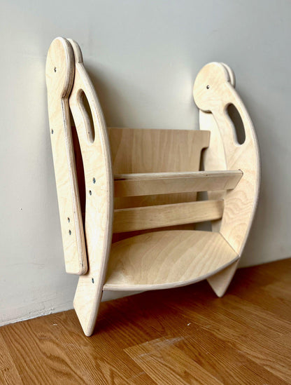 Red Oceanus foldable Montessori kitchen step stool for children, showing its compact, sturdy design and natural wood finish.